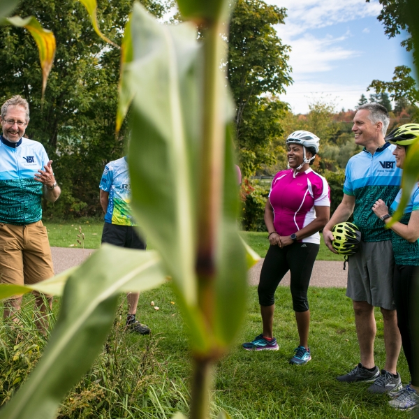 Trip leader sharing knowledge about local crops while on a bike tour in Stowe, Vermont